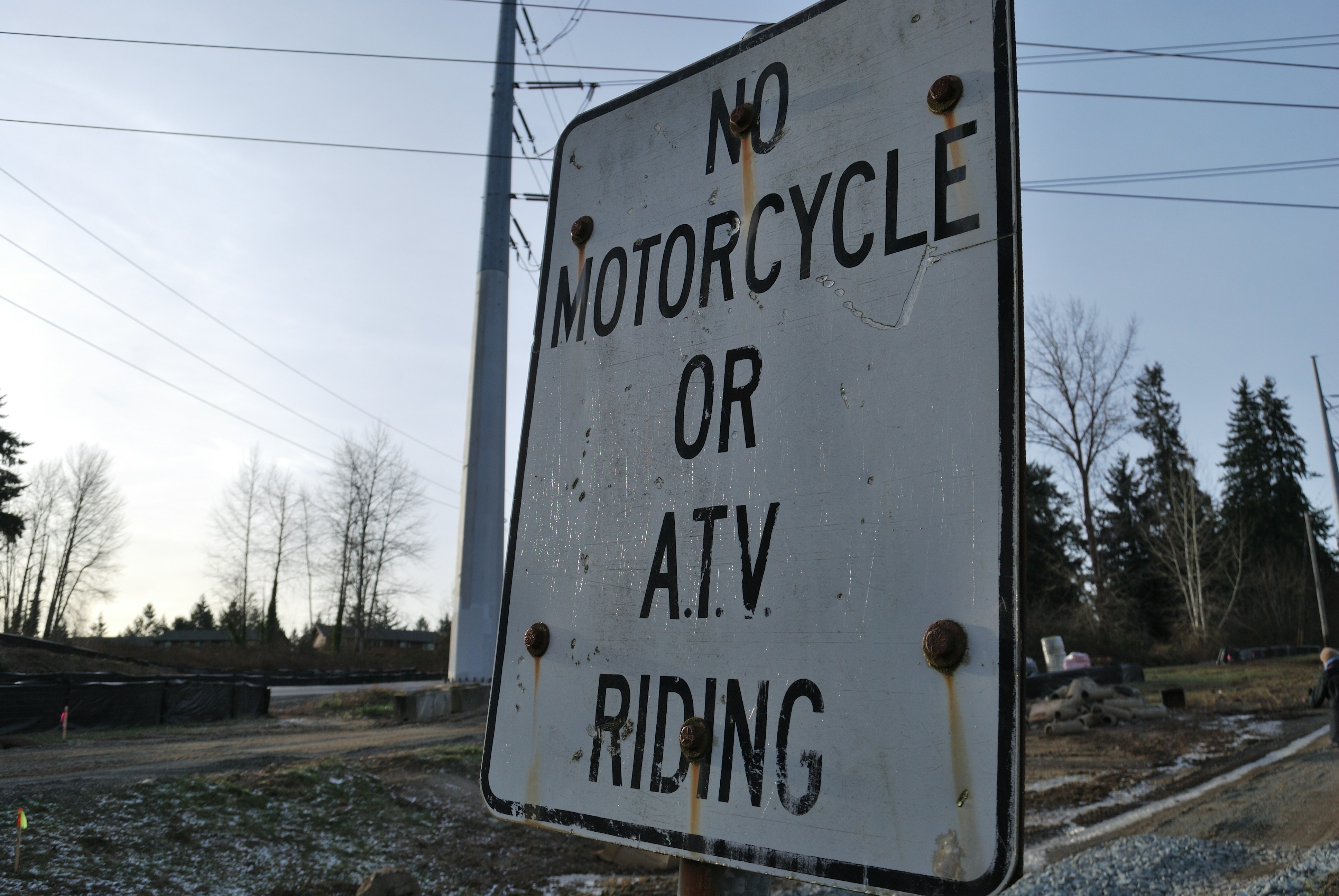 a white sign that says no motorcycle or atv riding