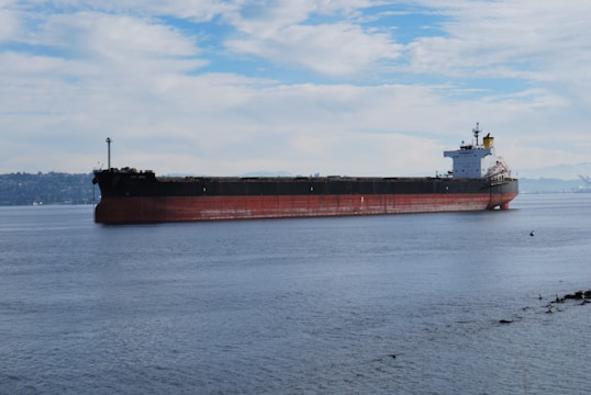 a large cargo ship floating on top of a large body of water