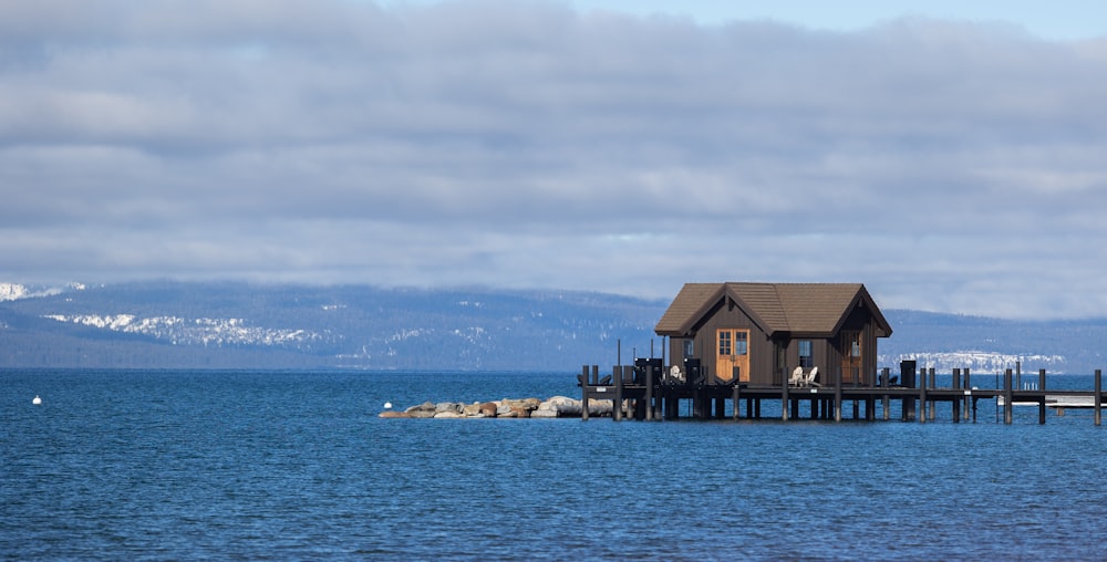 a house on a pier in the middle of the ocean