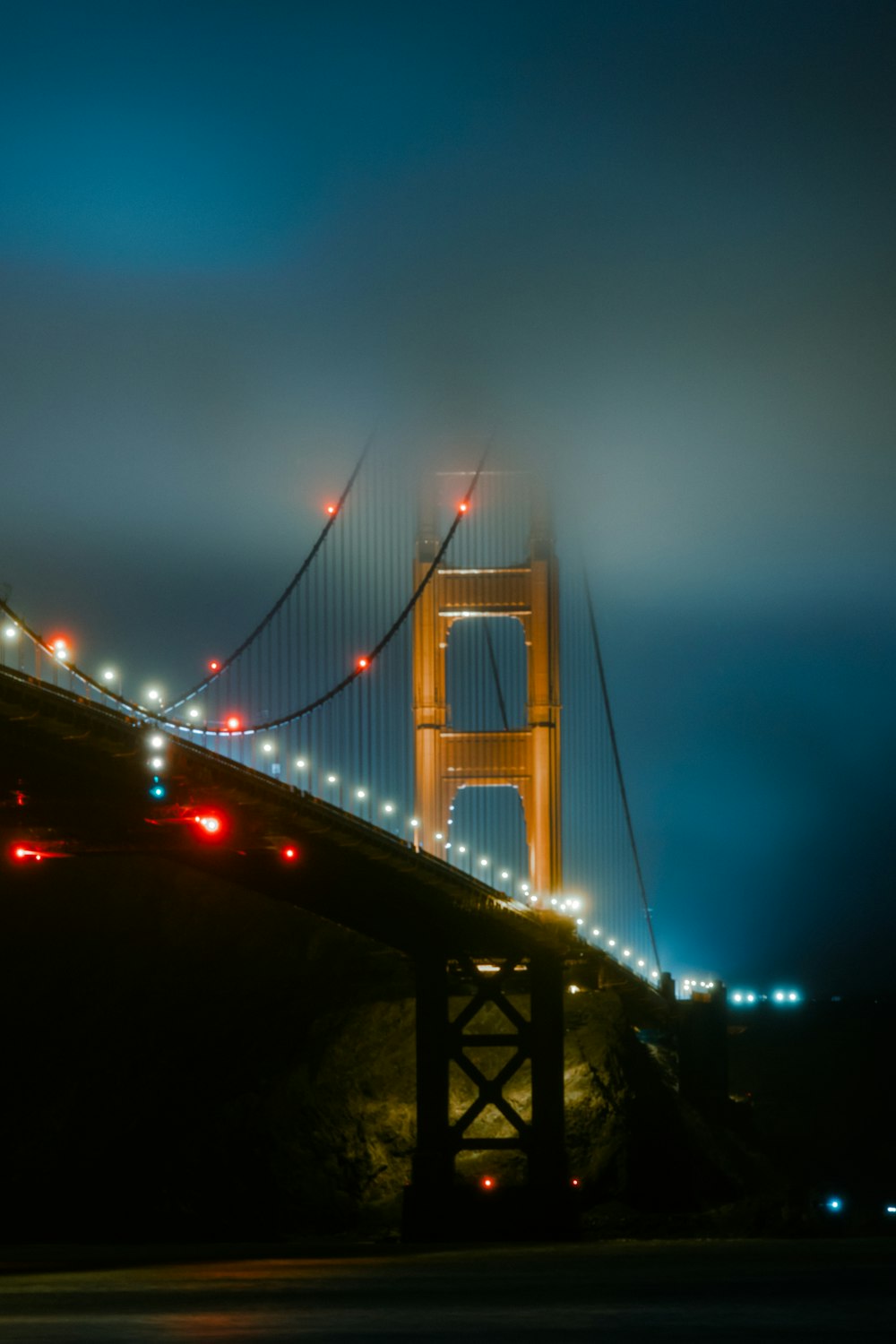 the golden gate bridge is lit up at night