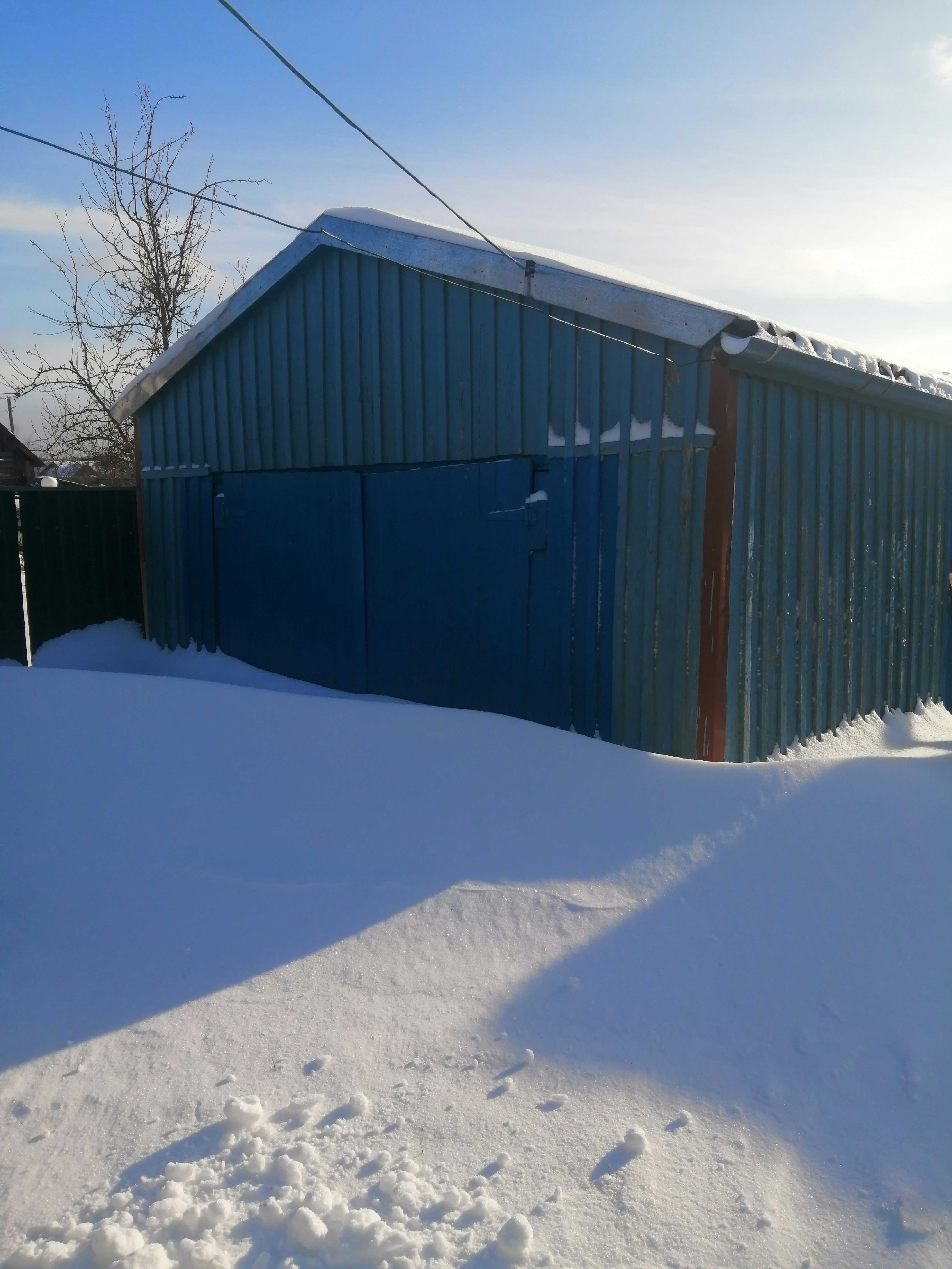 a snow covered yard next to a building