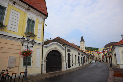 The main street of the town, with the church tower beyond — Tokaj, Hungary