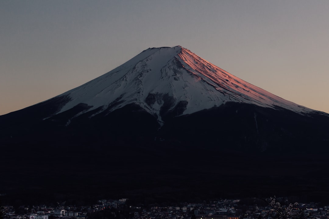 a snow covered mountain with a city below it, Sunset and Fuji-San Part II April 2019