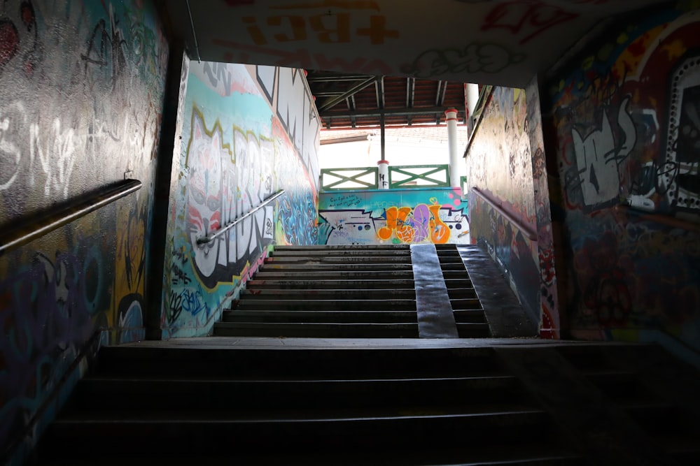 a stairway with graffiti painted on the walls
