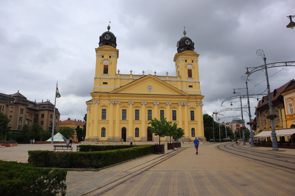 a large yellow building with two towers on top of it