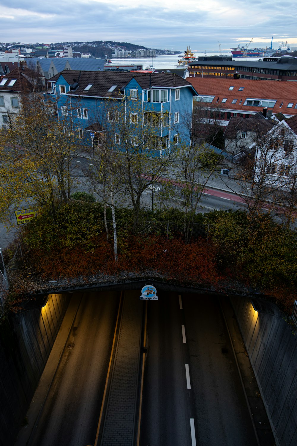 a train traveling through a tunnel next to tall buildings