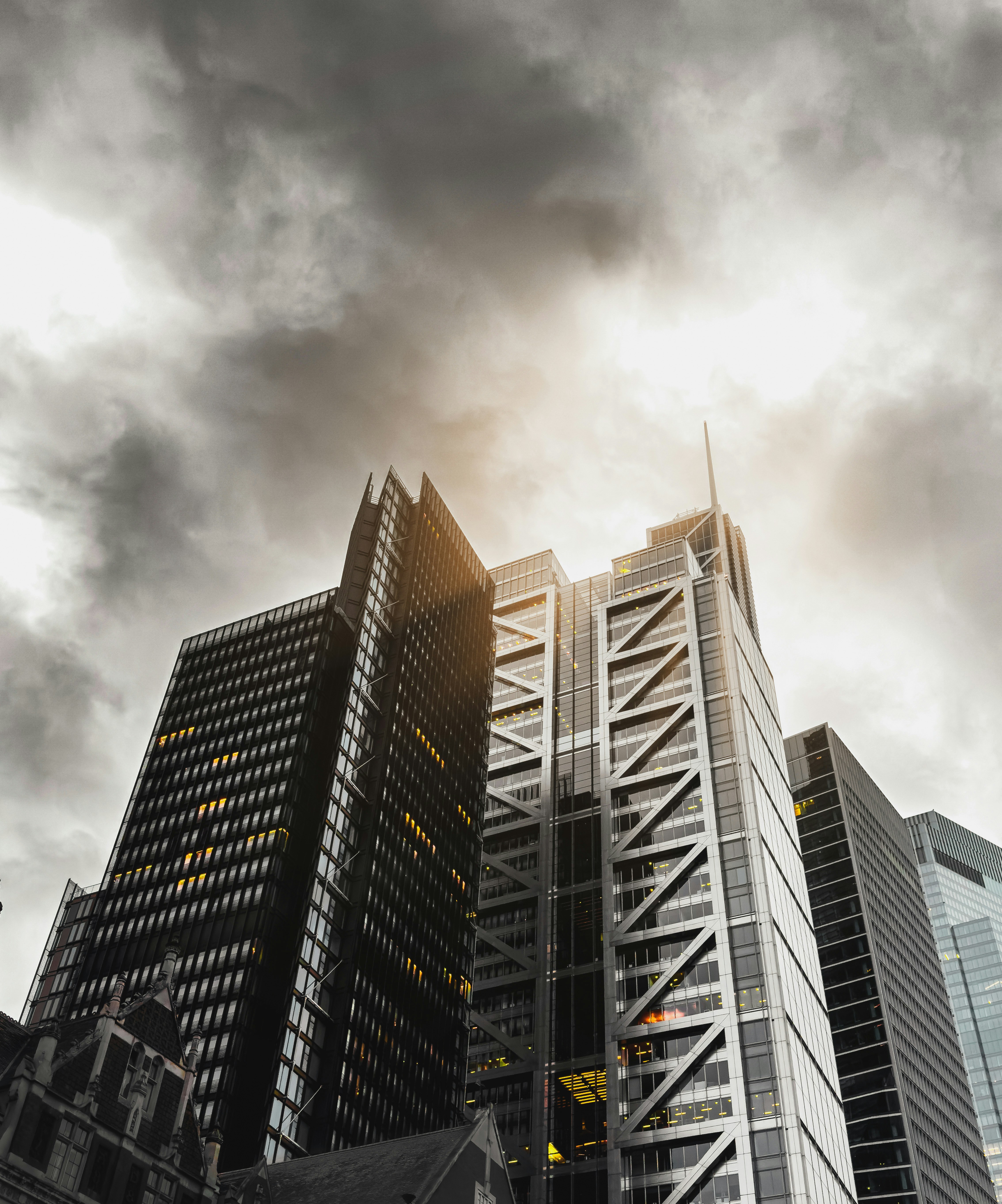 a very tall building sitting under a cloudy sky
