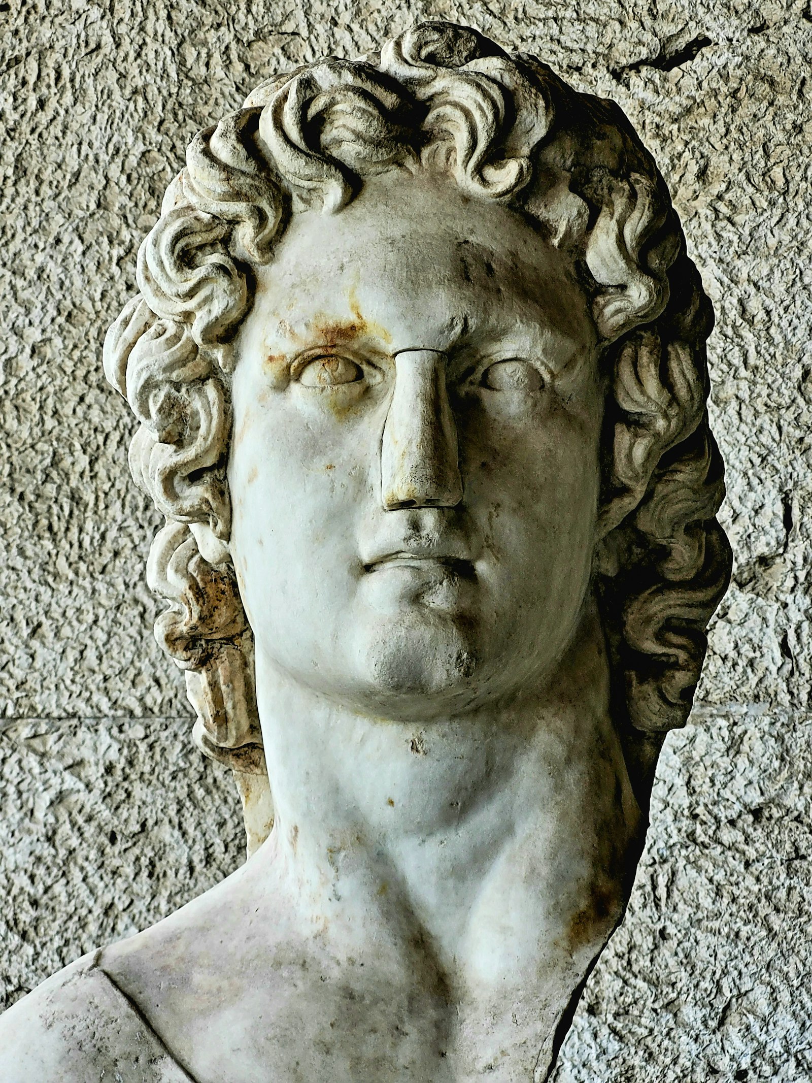 Marble bust of a man with curly hair, ancient Greek sculpture