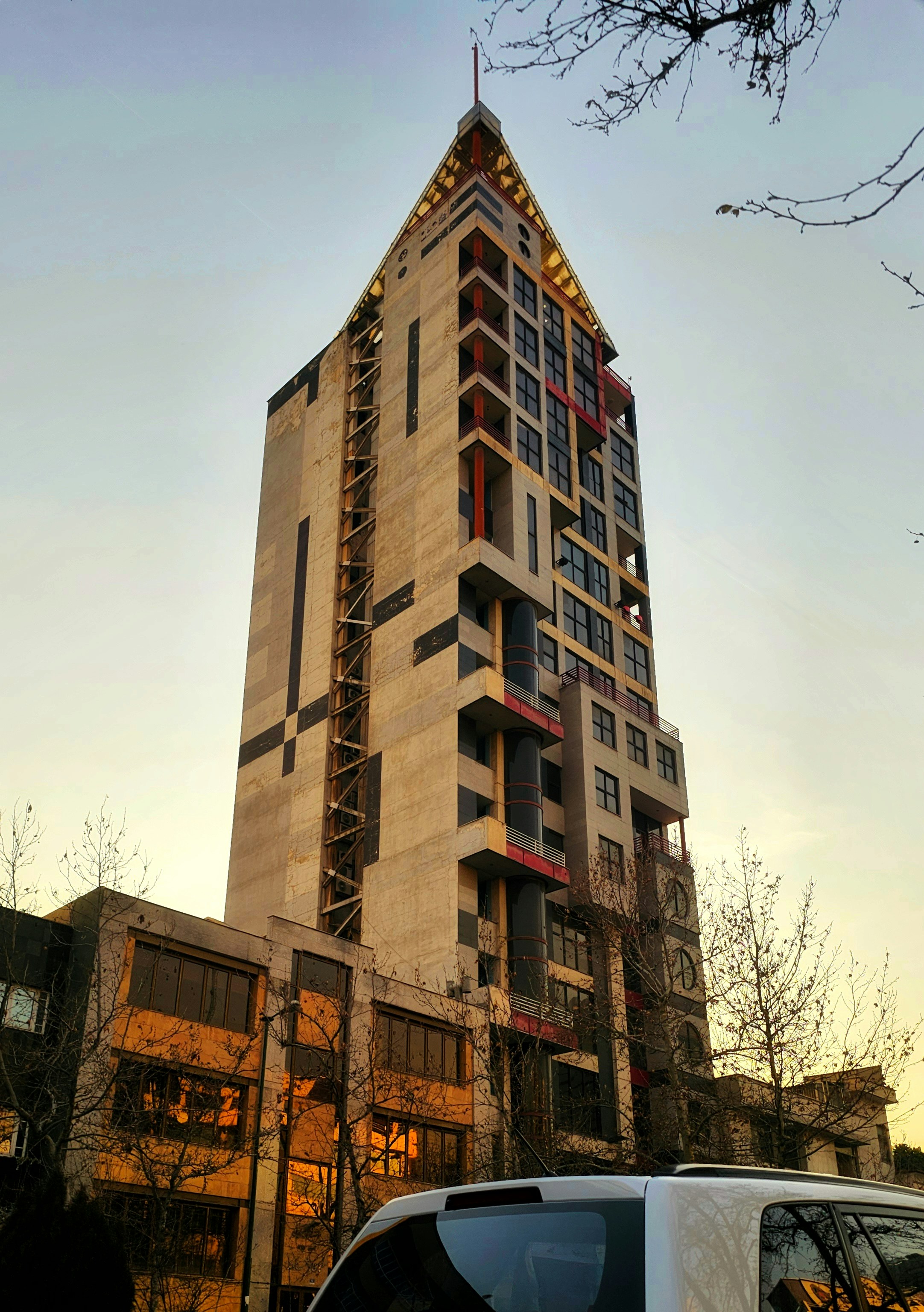 a van parked in front of a tall building