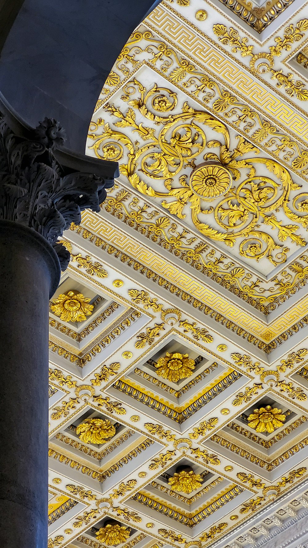the ceiling of a building with gold and white designs