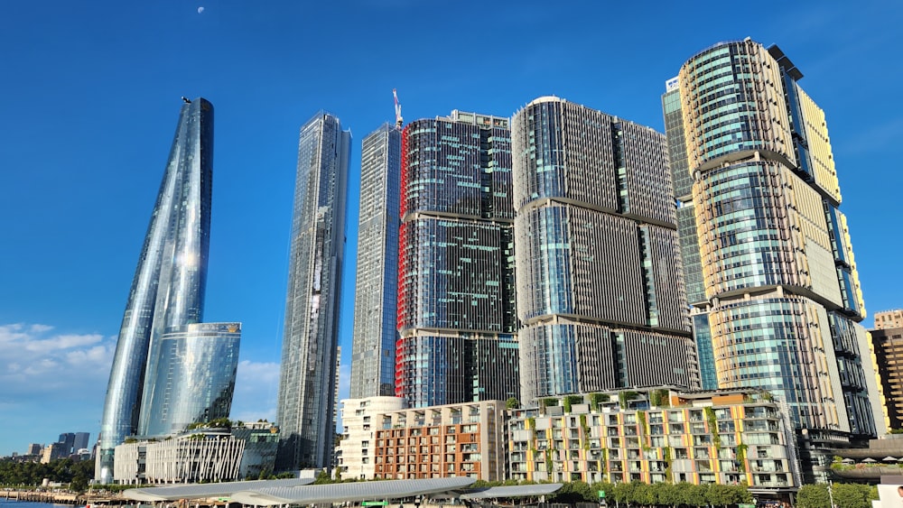 a group of tall buildings next to a body of water