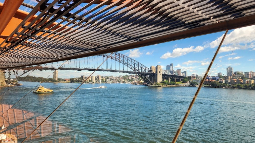 a boat traveling down a river next to a bridge