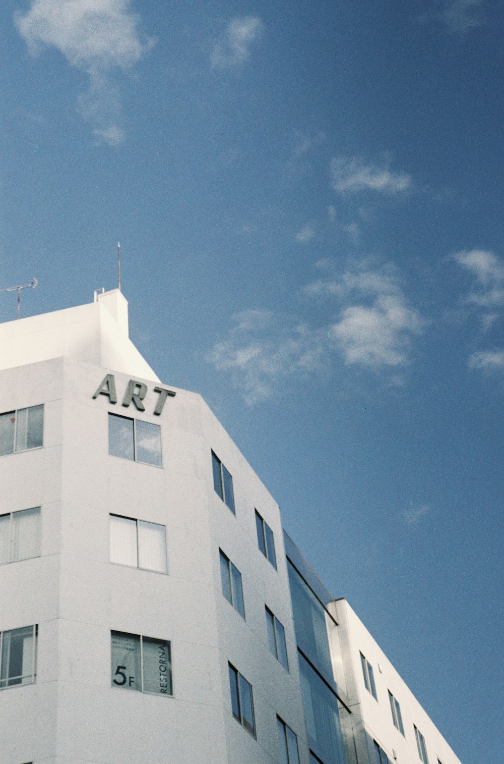 a tall white building with a clock on the top of it