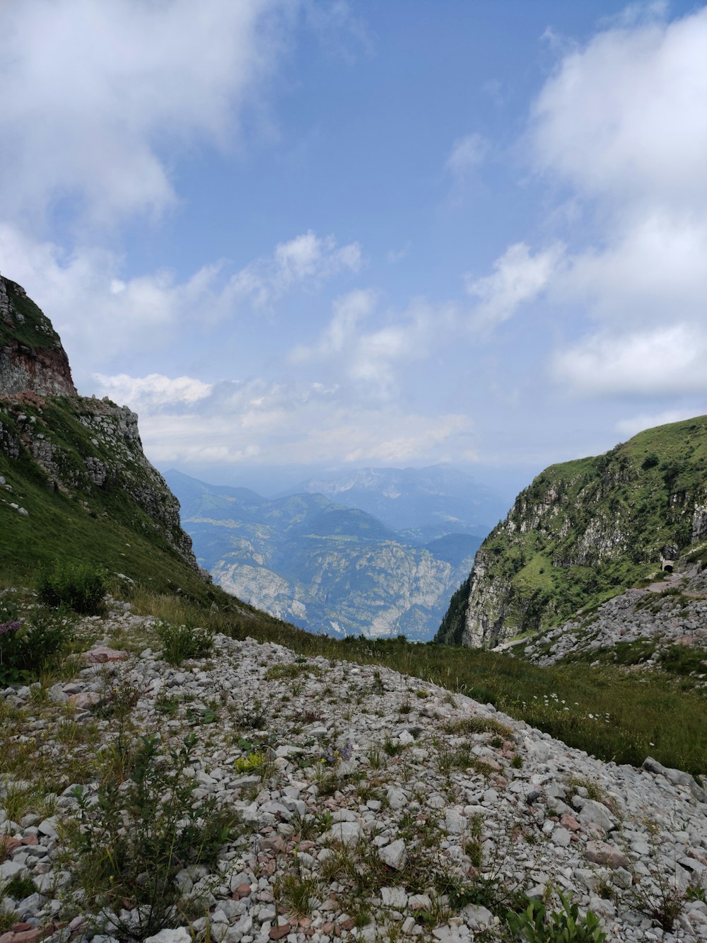 a view of a valley from a rocky hill