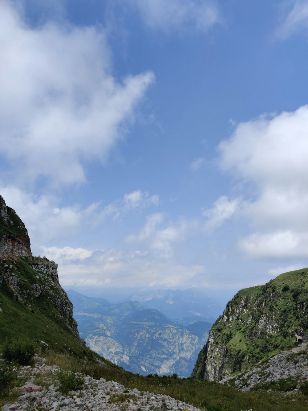 a view of a mountain range from the top of a hill