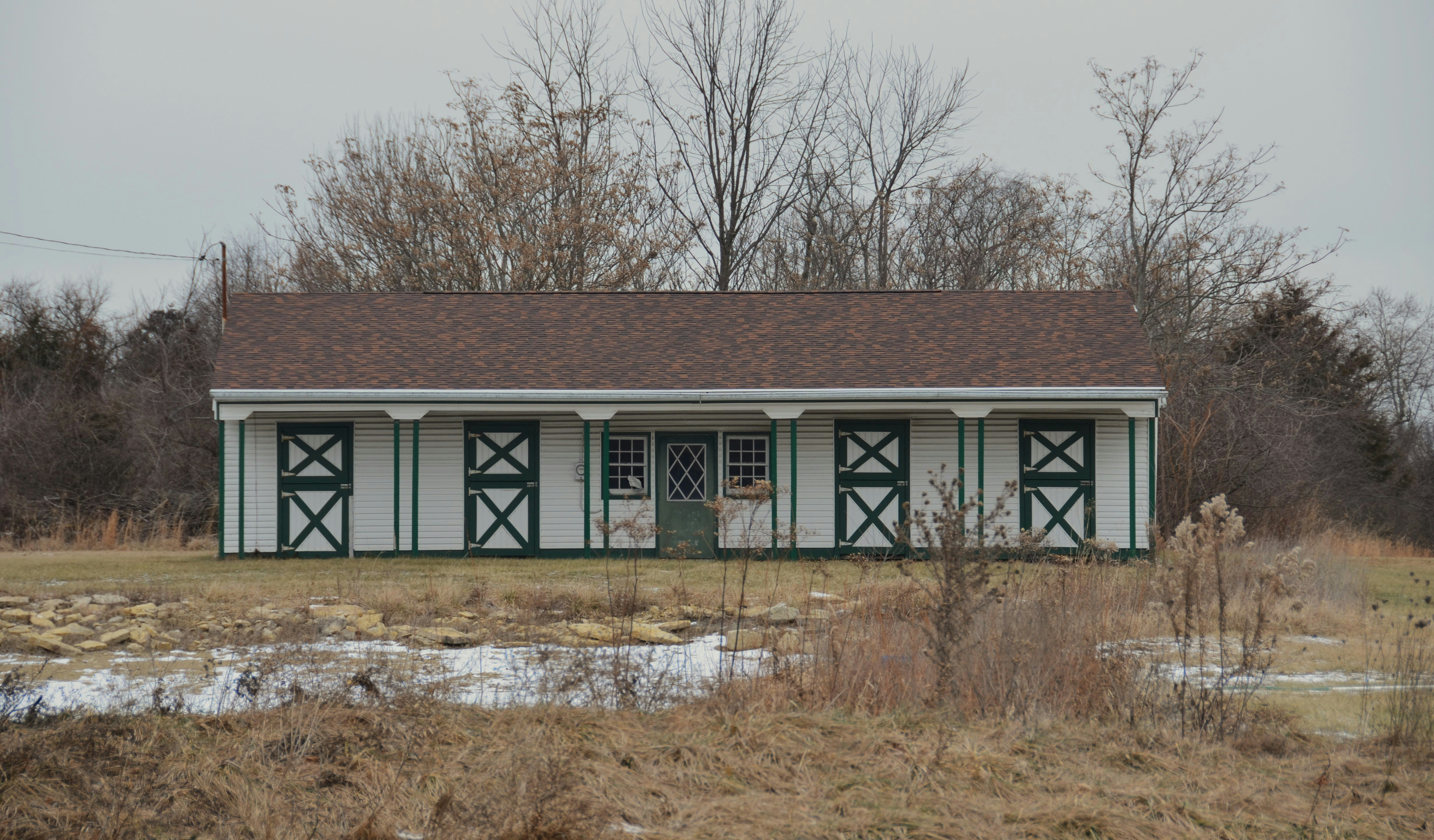 A small green and white building in a field photo – Free Outdoors Image ...