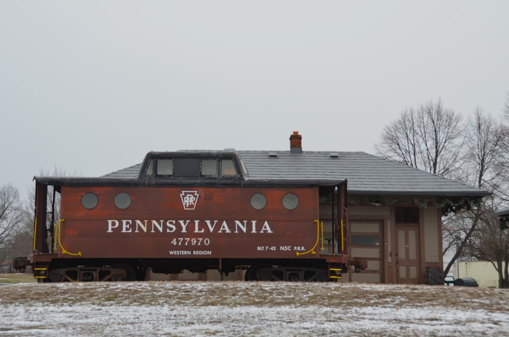 a train car sitting in front of a building