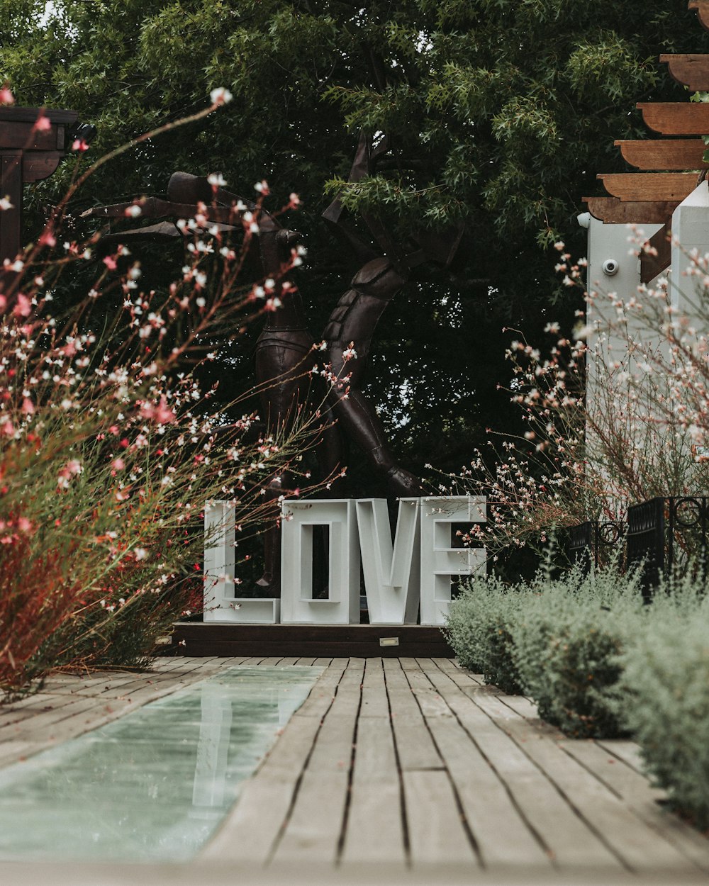 a sign that says love in front of a pool