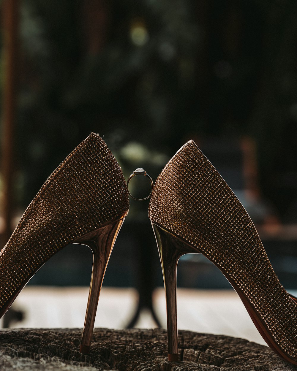 a pair of high heeled shoes sitting on top of a rock