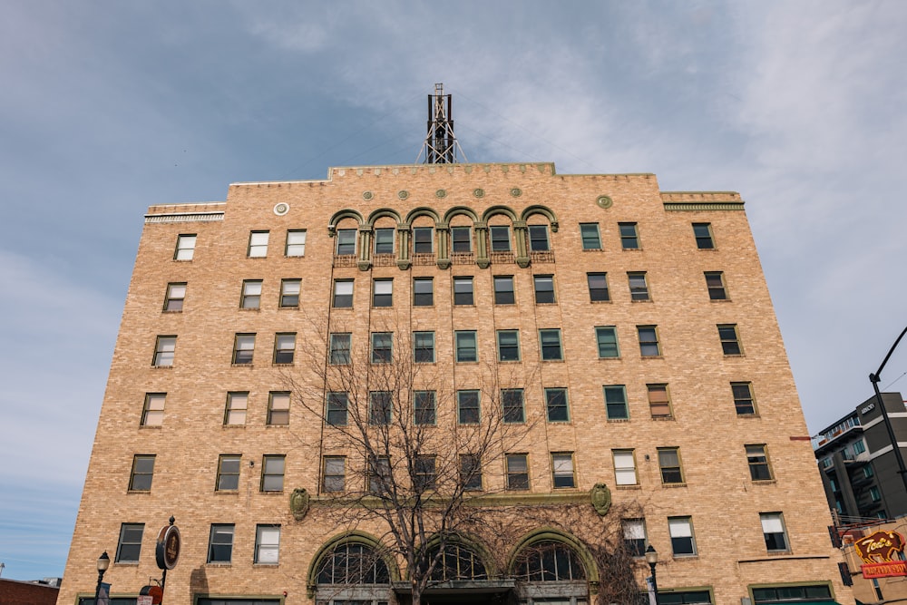 a tall brick building with a clock on the top of it