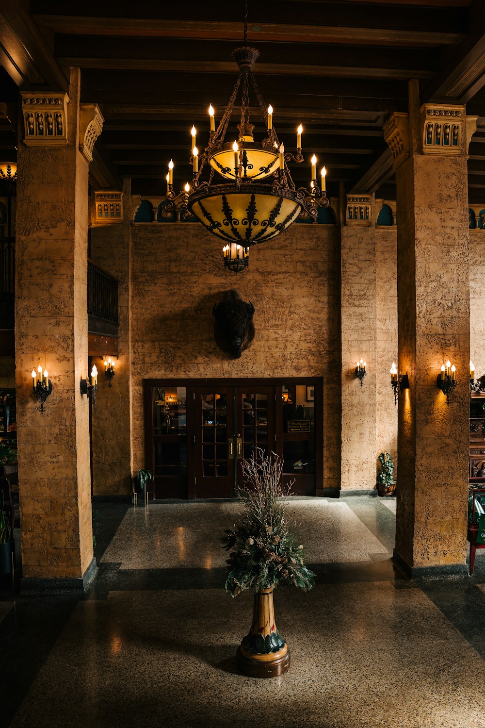 a chandelier hangs from the ceiling in a large room