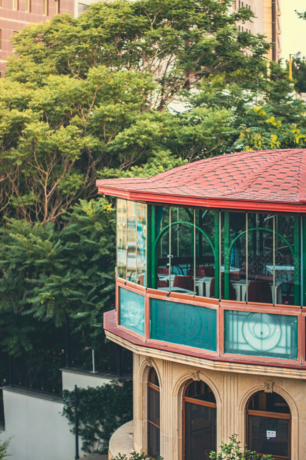 a building with a red roof and a green roof