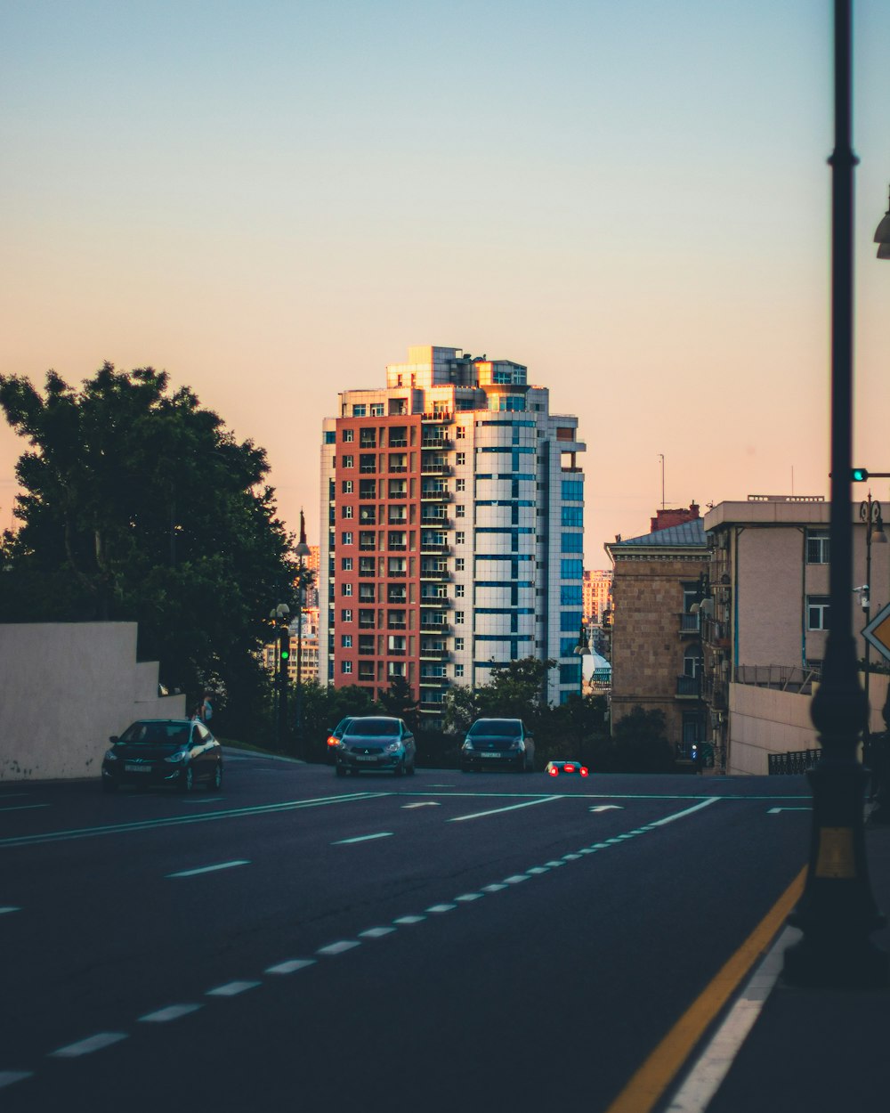 a city street with cars parked on the side of the road