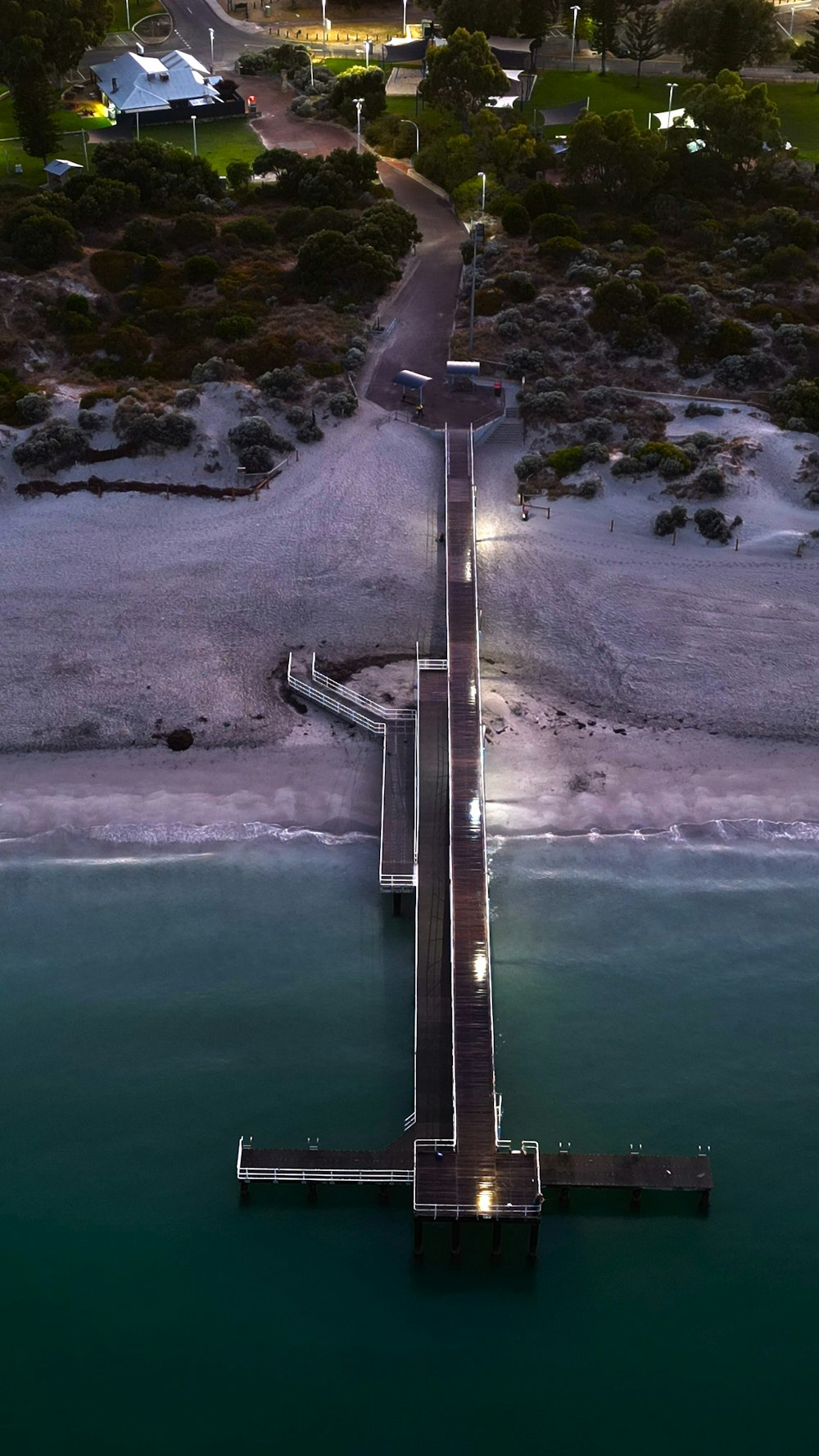 an aerial view of a pier at night