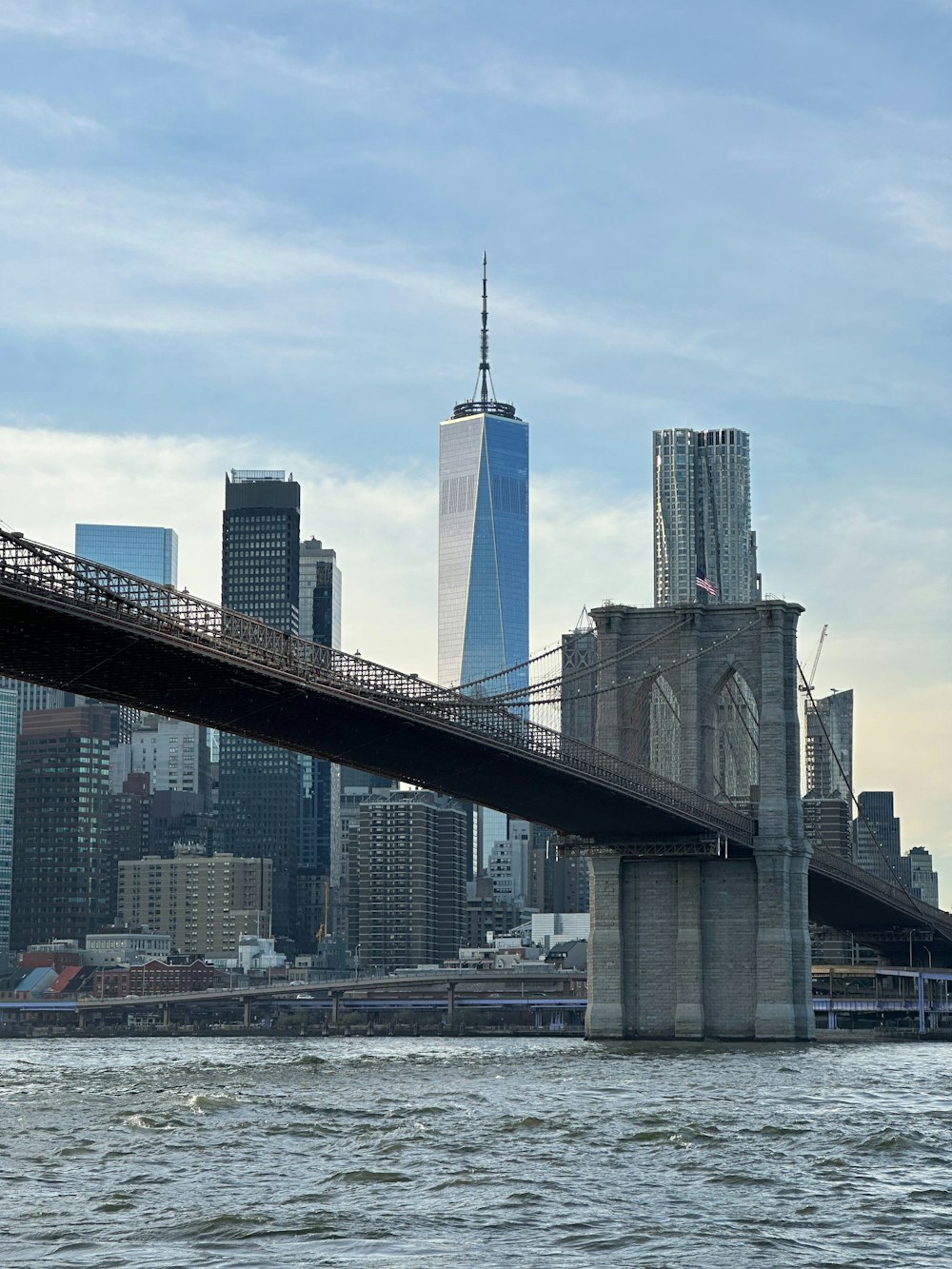 uma ponte sobre um corpo de água com uma cidade ao fundo