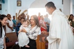 a woman holding a baby in a church