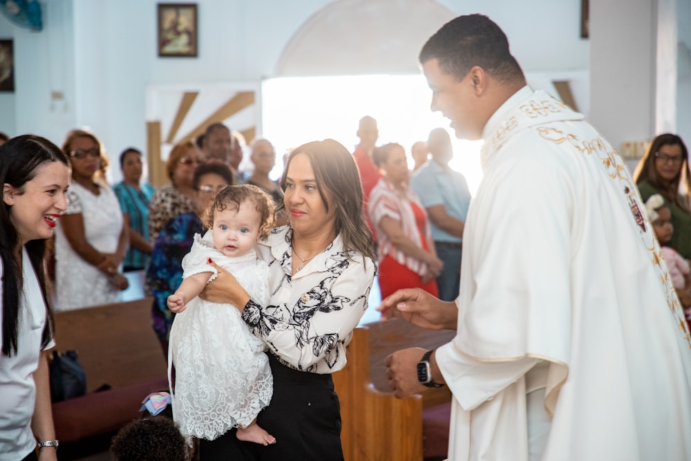 a woman holding a baby in a church