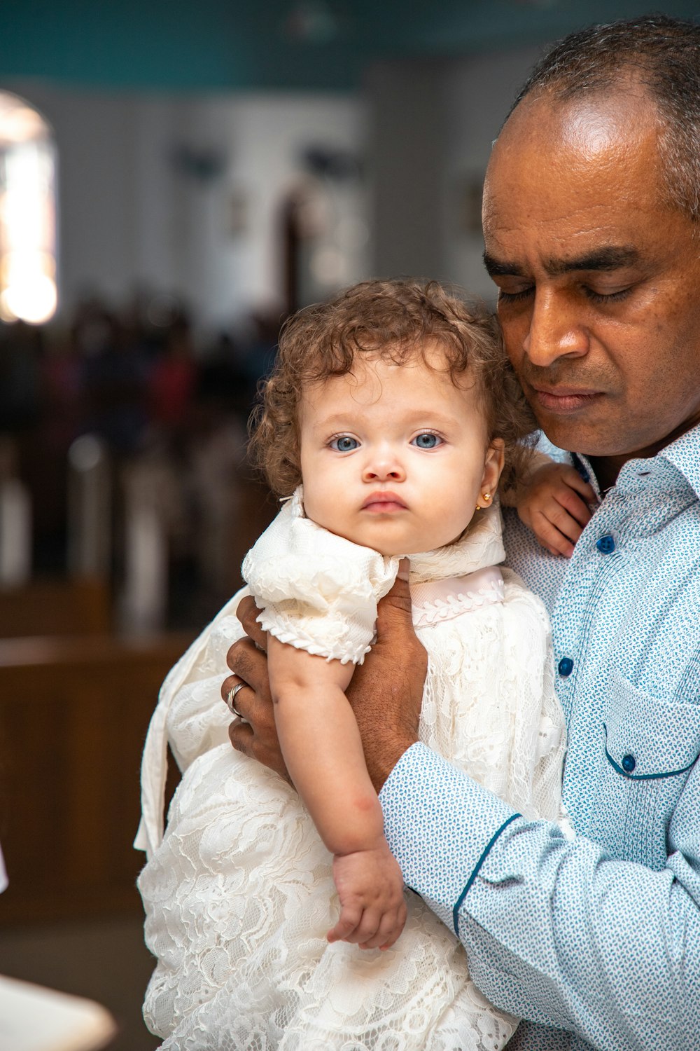 a man holding a little girl in his arms