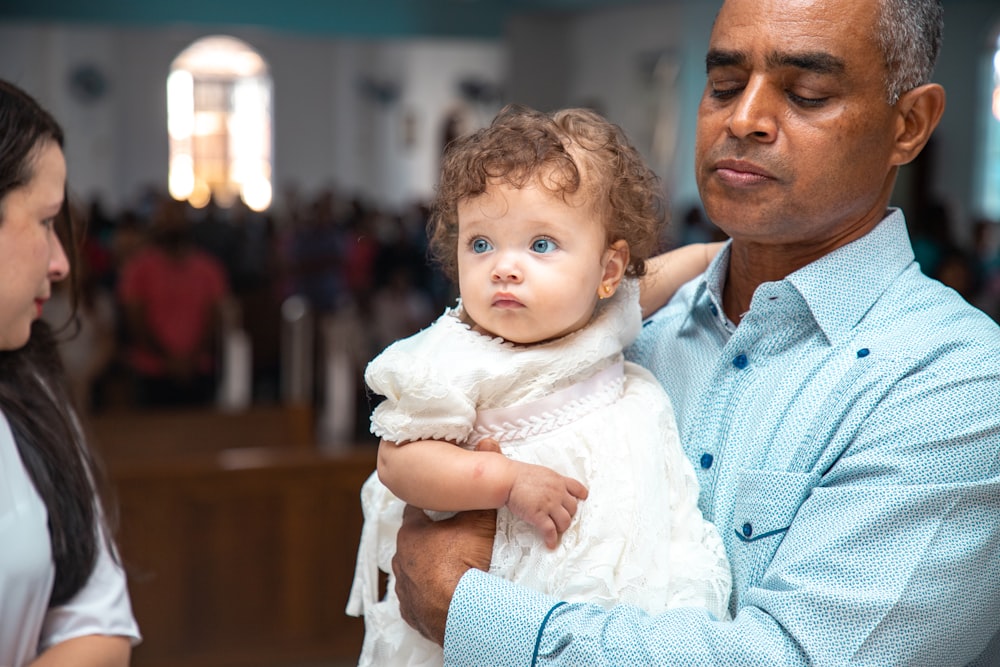 a man holding a baby in his arms