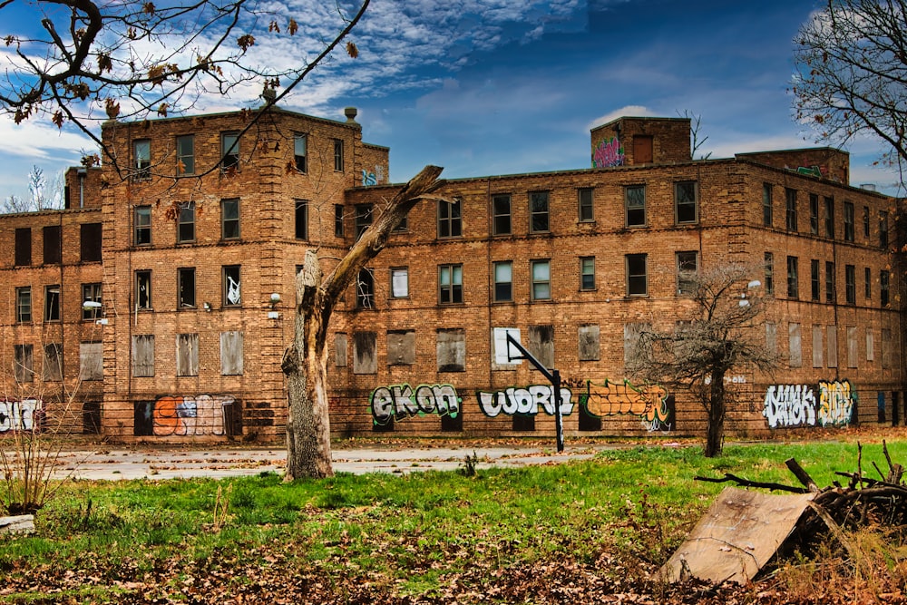 an old brick building with graffiti on it