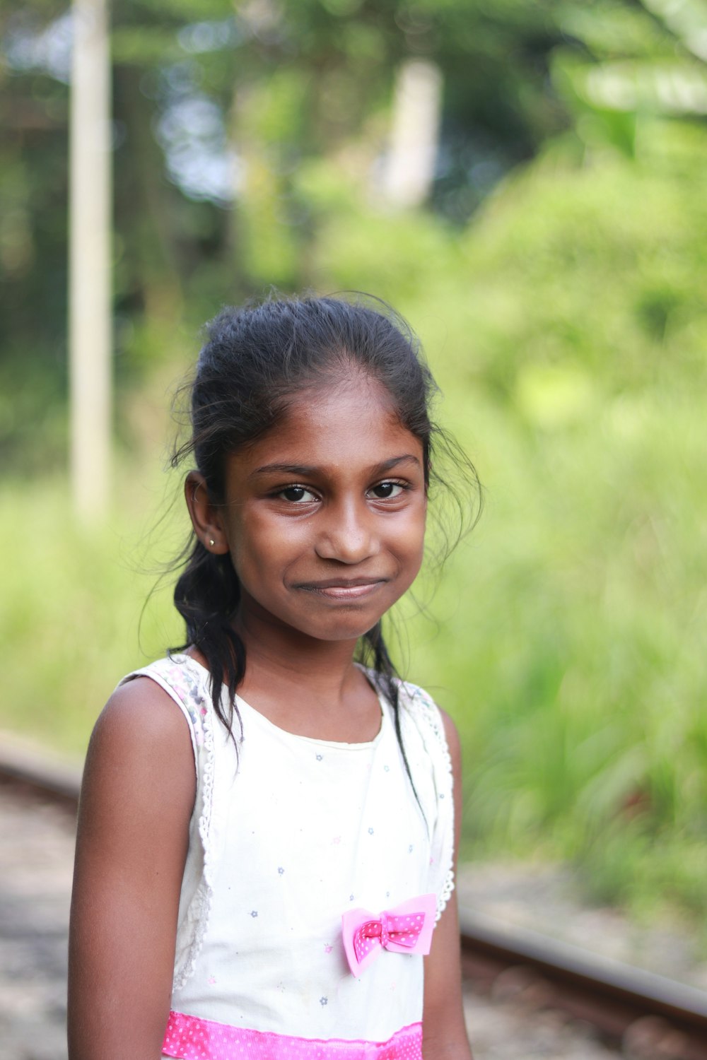 a young girl standing on a train track