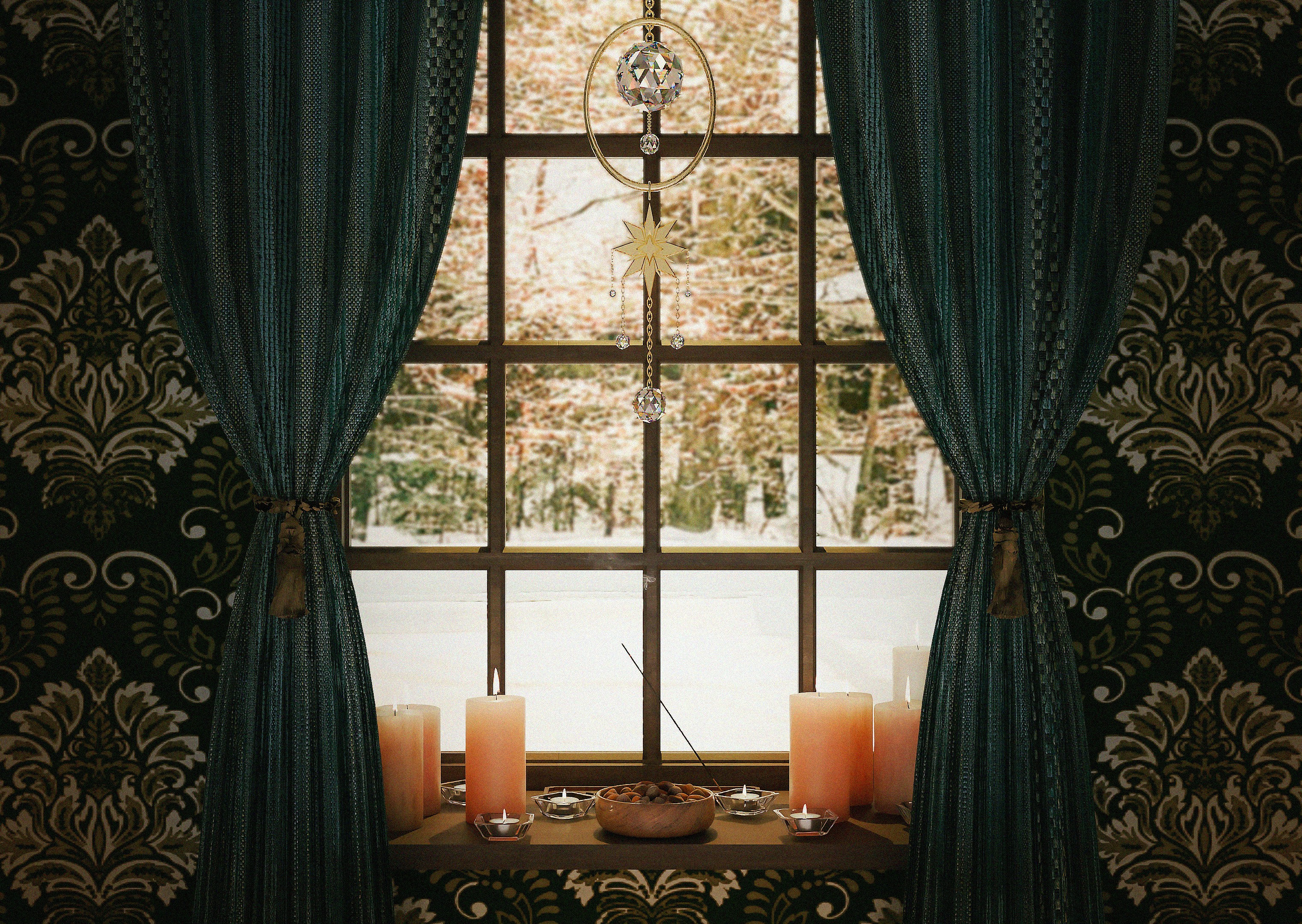 a window that has candles on a table in front of it