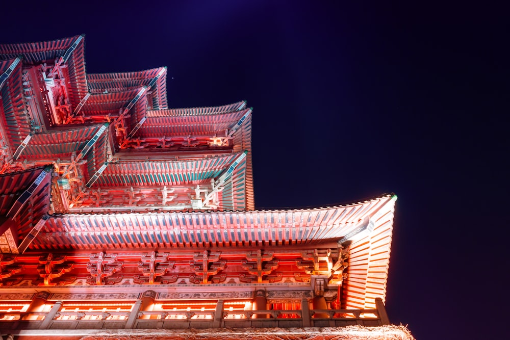 a tall building with lots of red lights on top of it