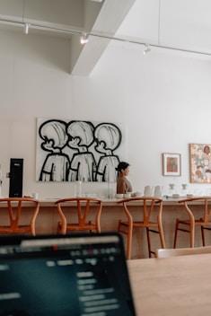 a laptop computer sitting on top of a wooden table