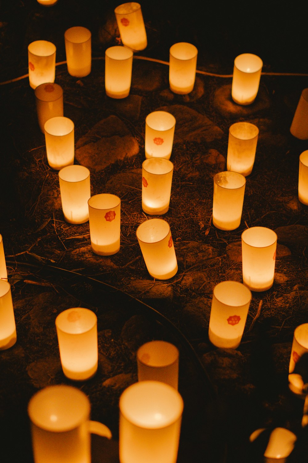 a bunch of lit candles sitting on top of a table