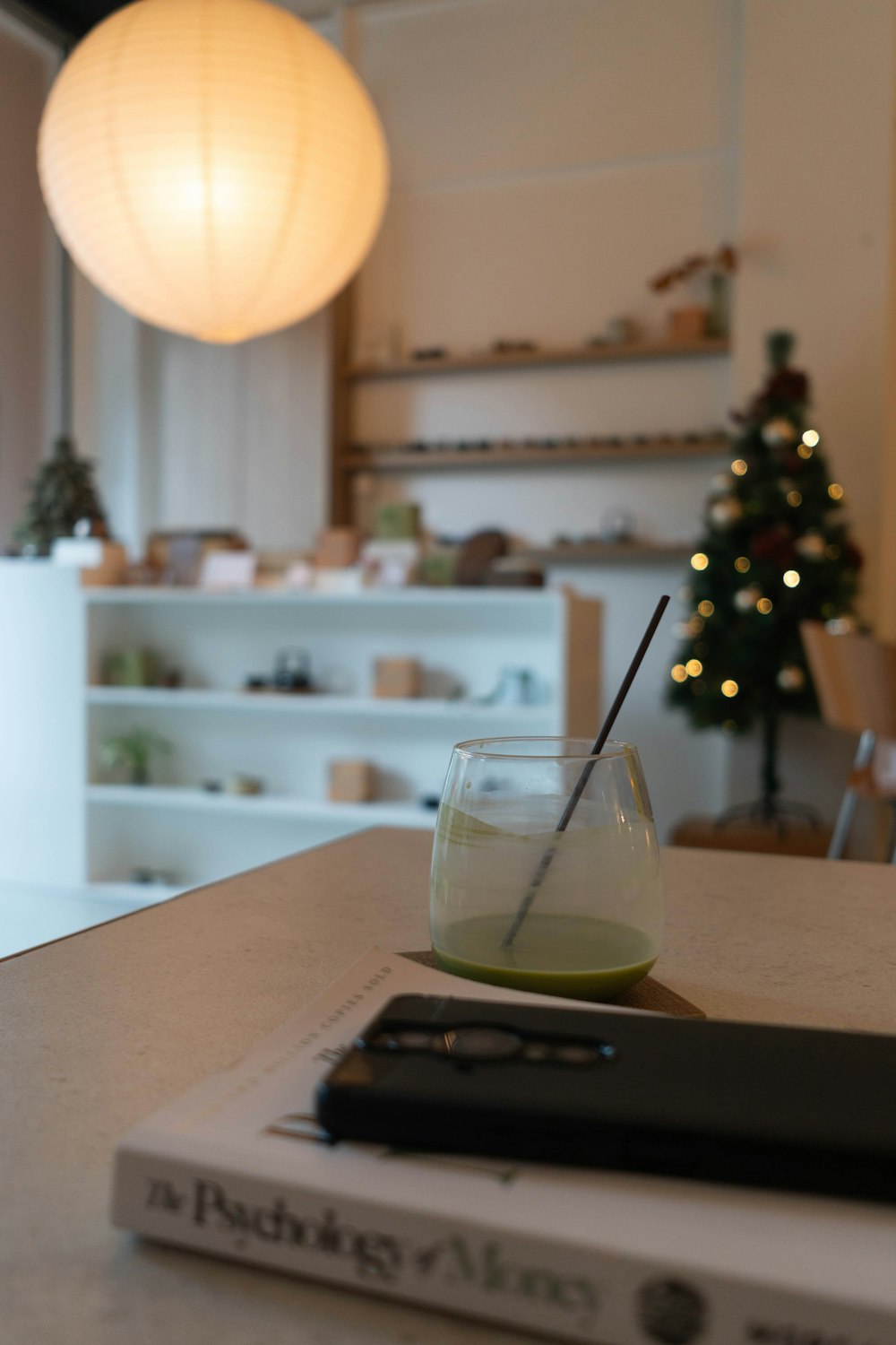 a glass filled with liquid sitting on top of a table