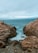 a couple of rocks sitting on top of a beach