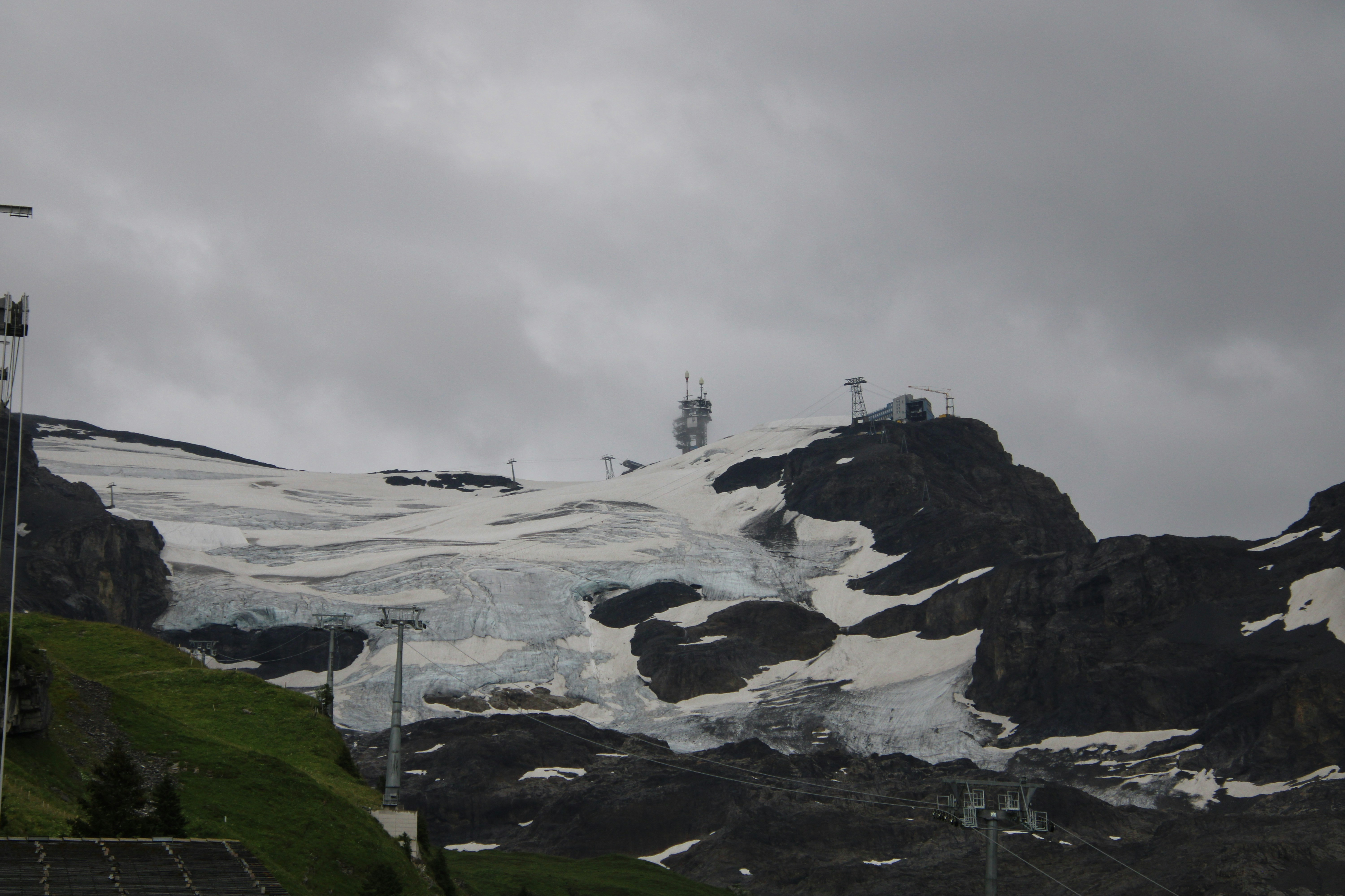 a snow covered mountain with a ski lift in the distance