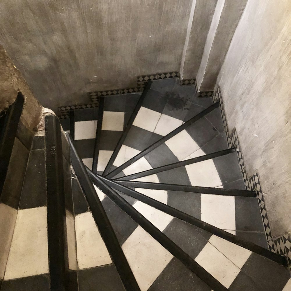 a black and white checkered floor with a spiral staircase
