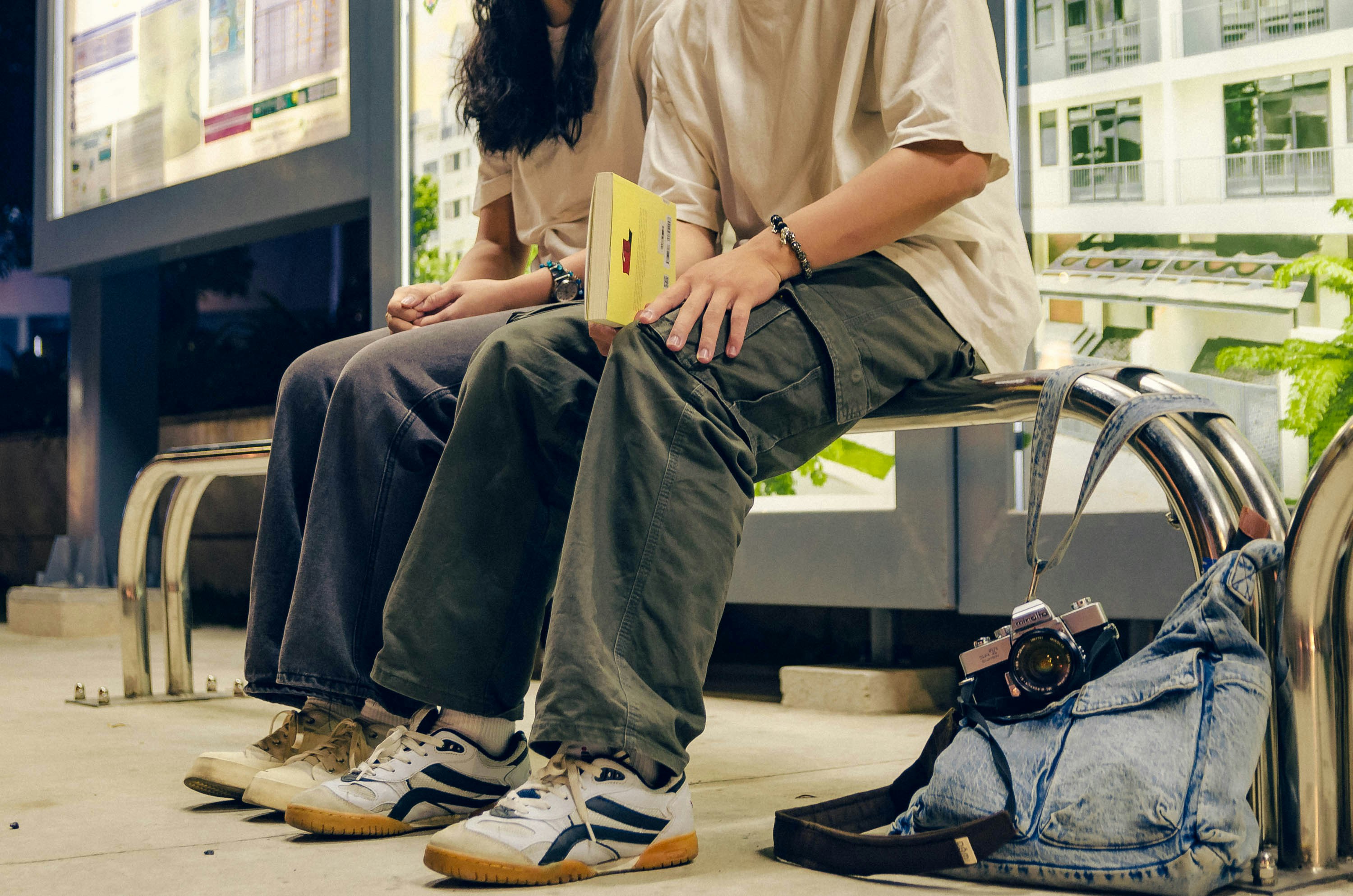 a man and a woman sitting on a bench