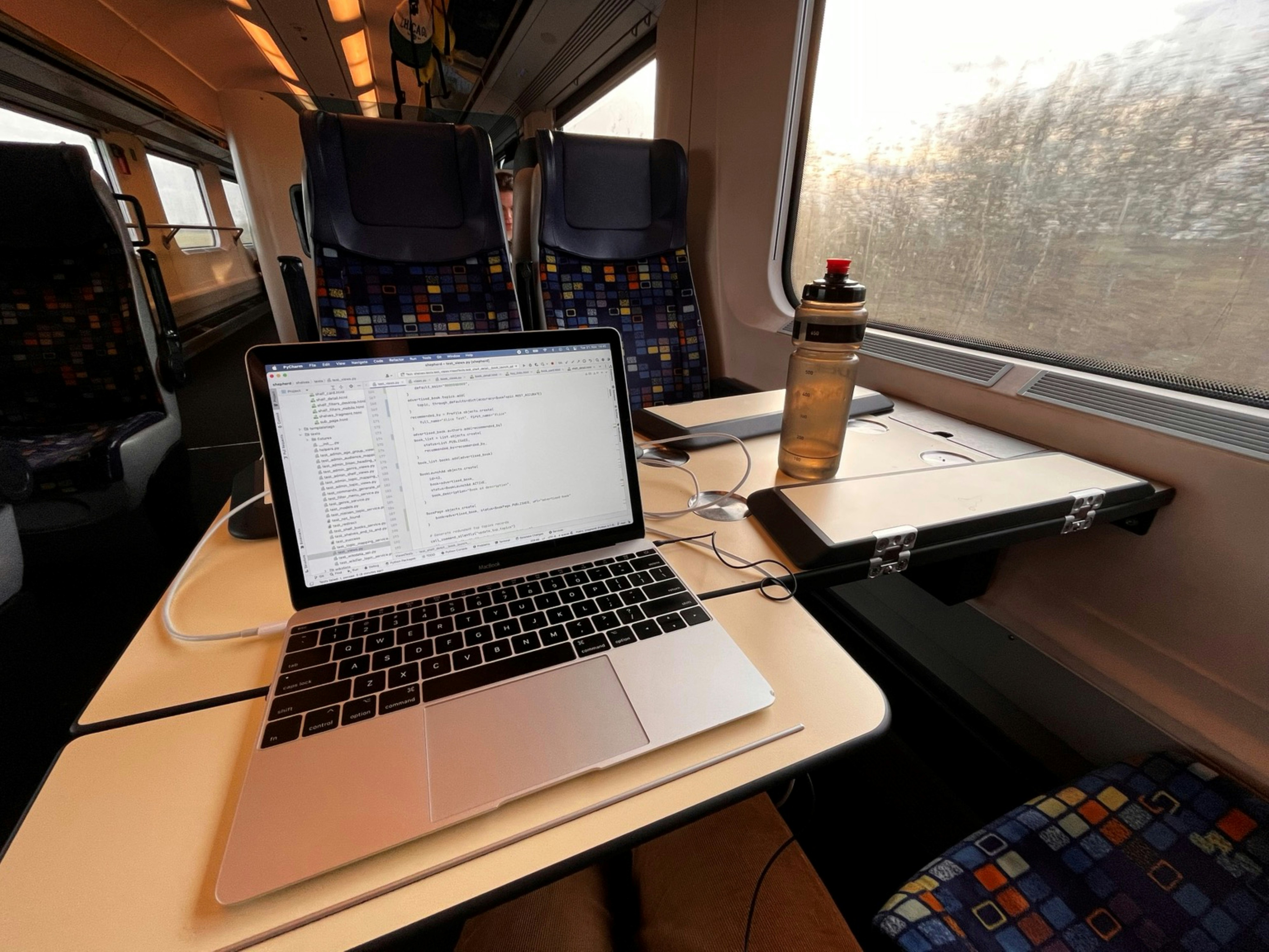 Man working on train with MacBook
