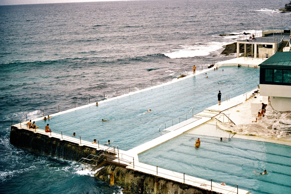 a large swimming pool next to the ocean