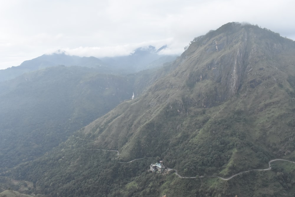 a very tall mountain with a road going up it