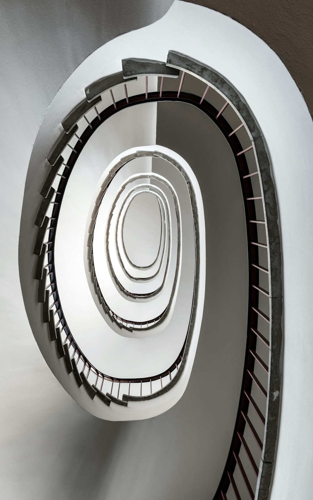 a spiral staircase in a building with white walls