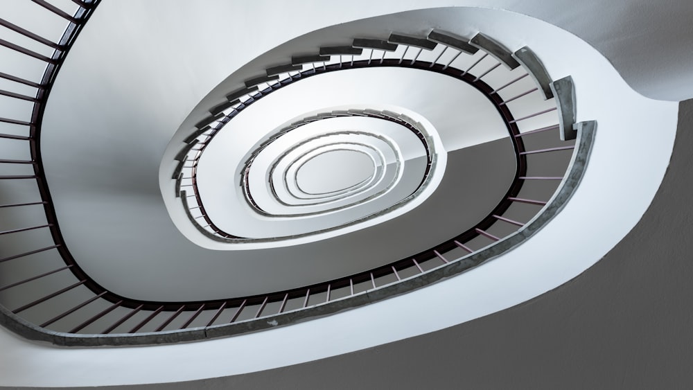 a spiral staircase in a building with white walls