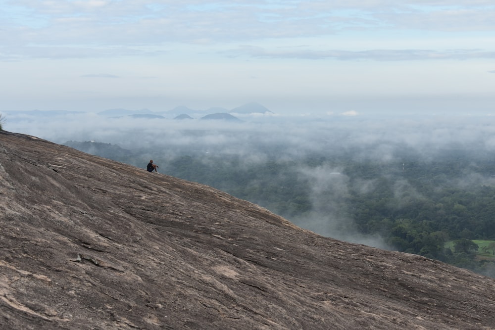 a person standing on top of a large rock